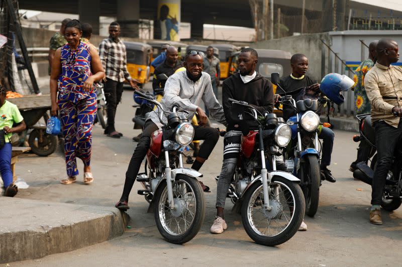 Motorcycle taxi drivers sit on their bikes, popularly called "Okada", in Obalende, Lagos Island, Nigeria