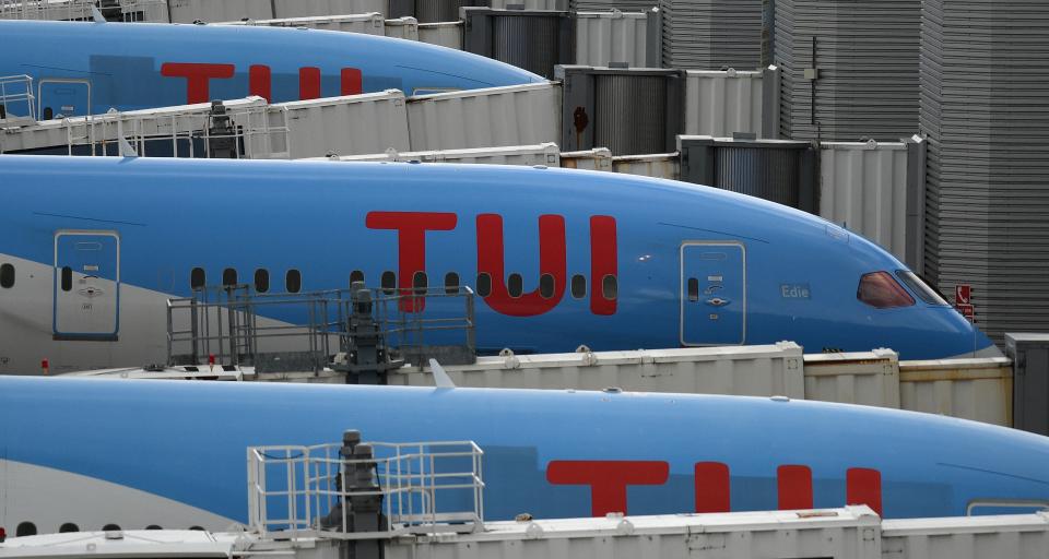 Aircraft grounded due to the COVID-19 pandemic, including planes operated by TUI are pictured on the apron at Manchester Airport in Manchester, north west England on May 1, 2020. - Irish low-cost carrier Ryanair said on Friday it planned to axe 3,000 pilot and cabin crew jobs, or 15 percent of staff, with air transport paralysed by coronavirus. Dublin-based Ryanair added in a statement that most of its flights would remain grounded until at least July and predicted it would take until summer 2022 at the earliest before passenger demand recovers. (Photo by Oli SCARFF / AFP) (Photo by OLI SCARFF/AFP via Getty Images)