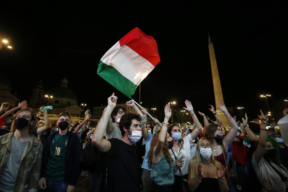 Italian fans watch the Euro 2020, soccer championship group A match between Italy and Turkey, on a mega screen set in downtown Rome, Friday, June 11, 2021. (Cecilia Fabiano/LaPresse via AP)