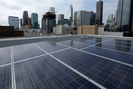 FILE PHOTO: Solar electric panels are shown installed on the roof of the Hanover Olympic building, the first building to offer individual solar-powered net-zero apartments in Los Angeles, California, U.S., June 6, 2017. REUTERS/Mike Blake/File Photo