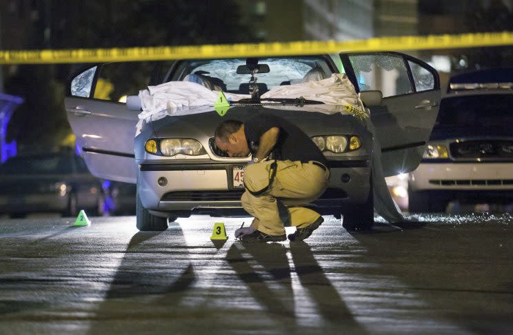 Police tape surrounds the car where Daniel de Abreu and Safiro Furtado were murdered. (AP)