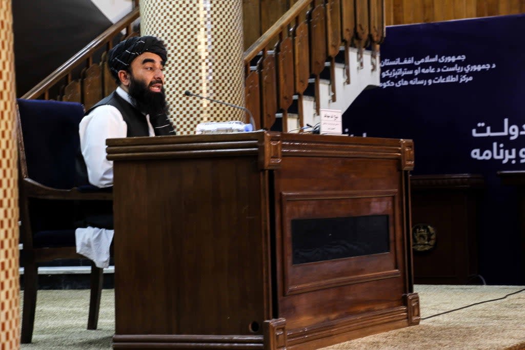 Zabhiullah Mujahid, the Taliban spokesperson, talks with journalists as he announces the interim government (EPA)