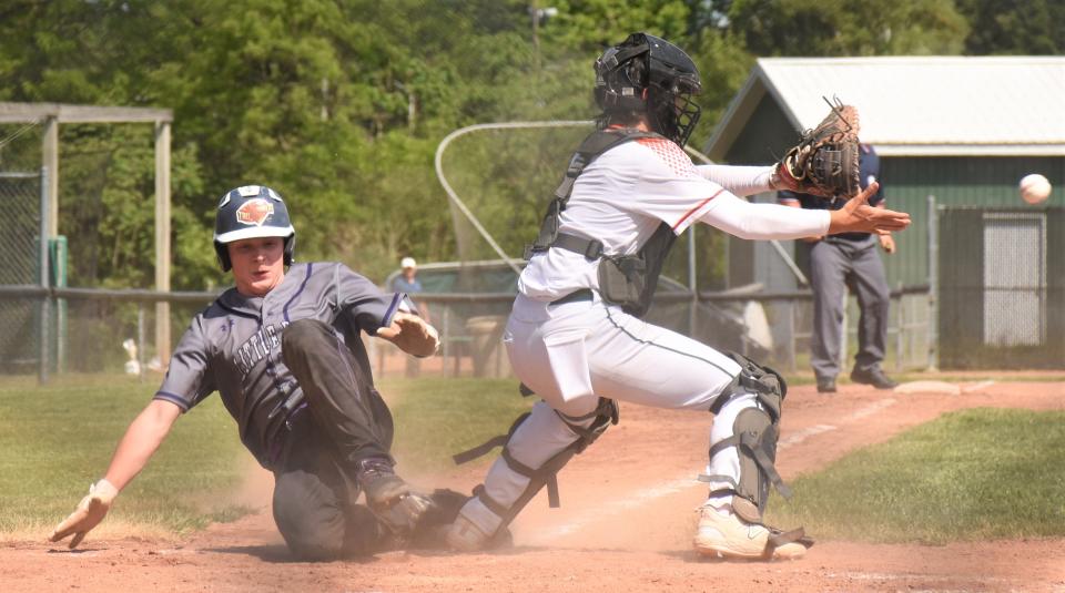 Sam Phillips (left) slides home safely and scores a run in the third inning of the Little Falls Mounties' Section III semifinal win over Beaver River.