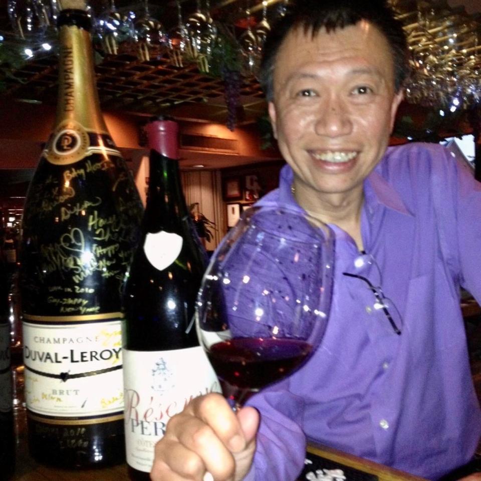 Kuan Lim, owner of Lucky Palace, tastes wine from his award-winning collection. Lucky Palace is a semifinalist in the 2020 James Beard Awards in the category of Outstanding Wine Program.