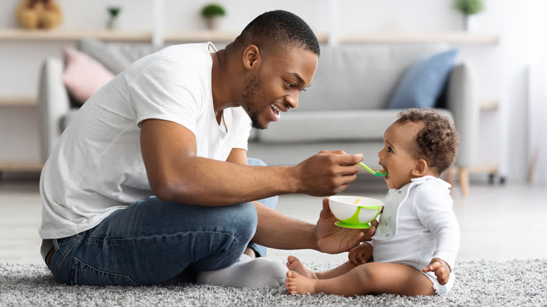 man feeding baby