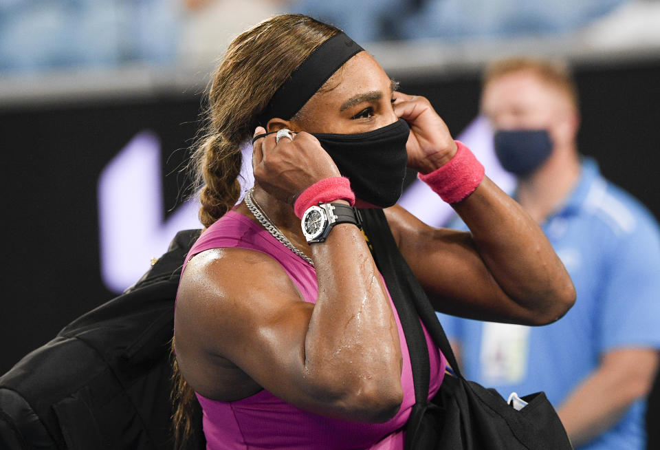 United States' Serena Williams adjusts her mask as she leaves the court following her match against compatriot Danielle Collins at a tuneup event ahead of the Australian Open tennis championships in Melbourne, Australia, Friday, Feb. 5, 2021.(AP Photo/Andy Brownbill)