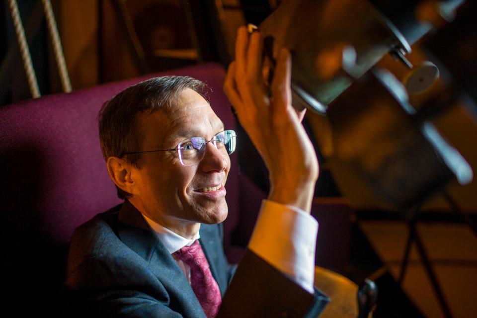 Harvard astrophysicist Avi Loeb looks through a telescope in Cambridge, Massachusetts on January 29, 2019.