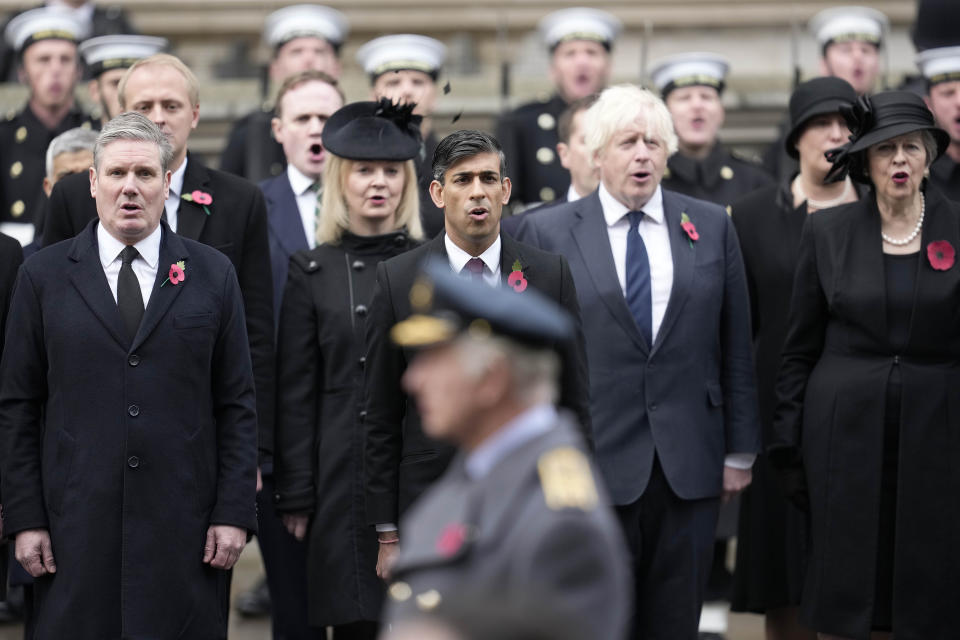 FILE - Britain's Prime Minister Rishi Sunak, center, stands with Labour Party leader Keir Starmer, left, former Prime Ministers Liz Truss, fourth right, Boris Johnson, second right, and Theresa May, right, to attend the Remembrance Sunday ceremony at the Cenotaph on Whitehall in London, Sunday, Nov. 12, 2023. (AP Photo/Kin Cheung, Pool, File)