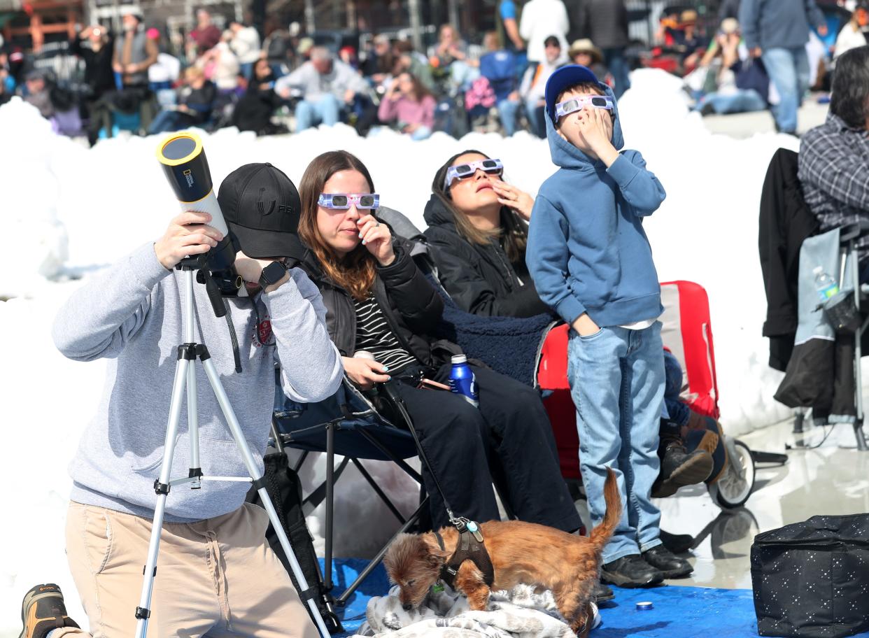 Spectators line the outdoor Olympic Skating Oval as they view the solar eclipse in Lake Placid, New York April 8, 2024.