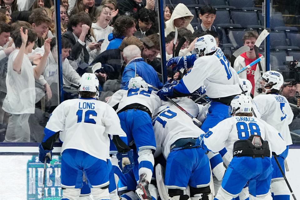Mar 11, 2023; Columbus, Ohio, USA;  Olentangy Liberty celebrates their 4-3 win over Cleveland St. Ignatius in the OHSAA state hockey semifinal at Nationwide Arena. Liberty won 4-3. Mandatory Credit: Adam Cairns-The Columbus Dispatch