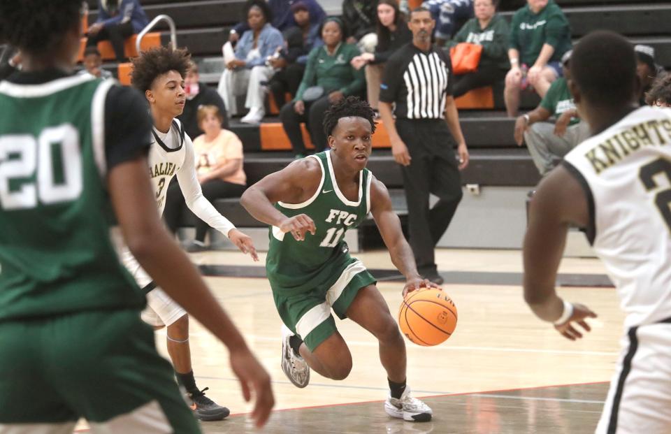 Flagler Palm Coast's Jameer Clark (11) drives into the lane against Halifax , Saturday, Jan. 13, 2024, during the Execute to Impact MLK Showcase Tournament at Spruce Creek High School.