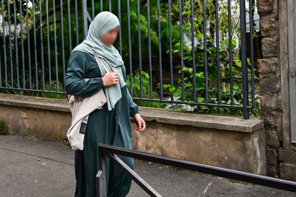 A photograph taken on August 28, 2023 shows a woman wearing an abaya walking in the streets of Paris. / Credit: MIGUEL MEDINA/AFP via Getty