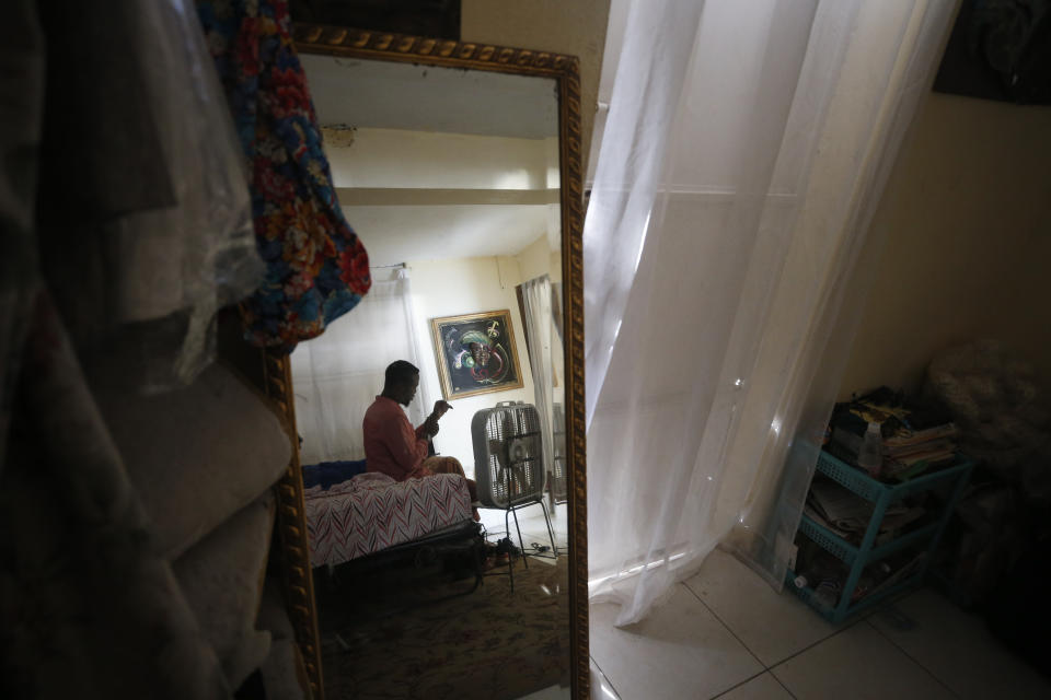 Entrepreneur and youth leader Pascéus Juvensky St. Fleur, 26, prepares for an interview with the AP inside his family's home in the Delmas neighborhood of Port-au-Prince, Haiti, Tuesday, Oct. 8, 2019. St. Fleur says the protests are not only about replacing a president, but changing a system. "It's not one person, it's not one regime, it's not a president, it's not the opposition, it's not the bourgeoisie, but it's us who should do it," he said. "We dream of, and we want, a better Haiti."(AP Photo/Rebecca Blackwell)