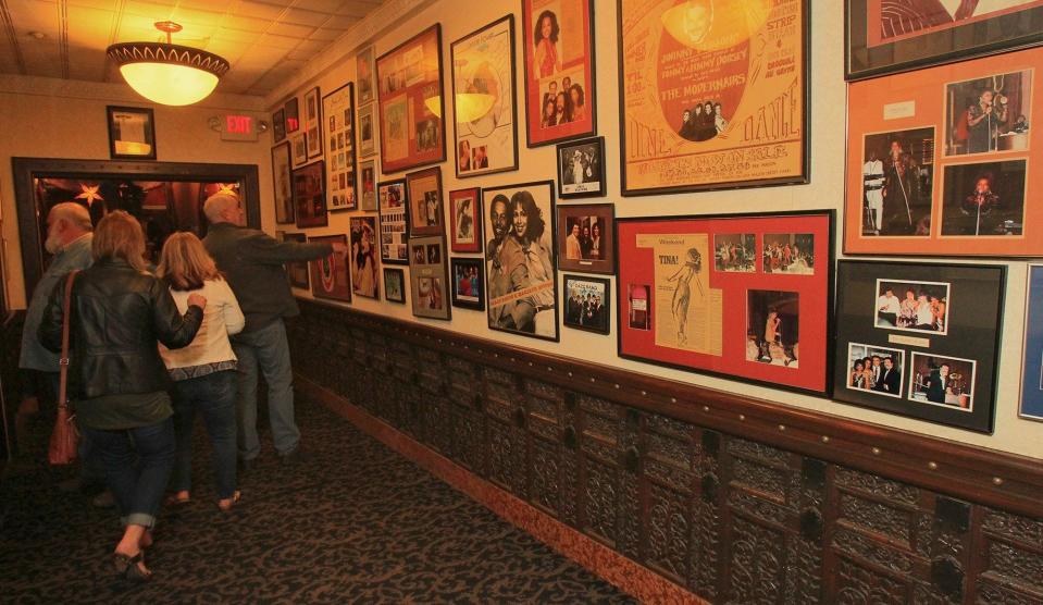 Tangier visitors look over entertainment memorabilia hanging on the walls of the Akron landmark in 2015.