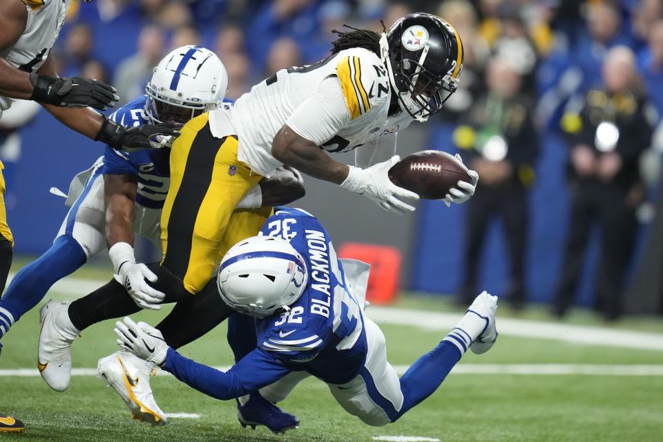 Pittsburgh Steelers' Najee Harris (22) runs for a touchdown against Indianapolis Colts' Julian Blackmon (32) during the first half of an NFL football game, Monday, Nov. 28, 2022, in Indianapolis. (AP Photo/Michael Conroy)