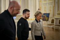 Ukrainian President Volodymyr Zelenskyy, center, welcomes European Commission President Ursula von der Leyen, right, and European Council President Charles Michel, during the EU-Ukraine summit in Kyiv, Ukraine, Friday, Feb. 3, 2023. (Ukrainian Presidential Press Office via AP)