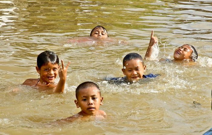 The boys: The stronger boys managed to climb into my boat and not knowing what to do once they were there, just gave me a big smile and fell back into the water. (