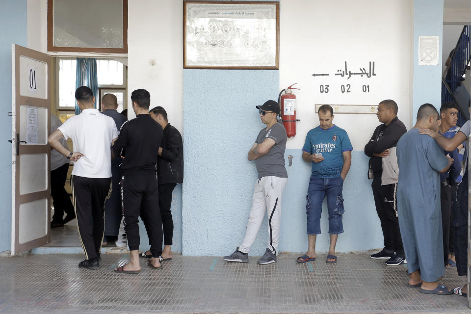 People queue to cast their vote outside a polling station during the country's first legislative elections sine the ouster of ex-president Bouteflika, in Algiers, Algeria, Saturday, June 12, 2021. Algerians vote Saturday for a new parliament in an election with a majority of novice independent candidates running under new rules meant to satisfy demands of pro-democracy protesters and open the way to a "new Algeria." (AP Photo/Toufik Doudou)