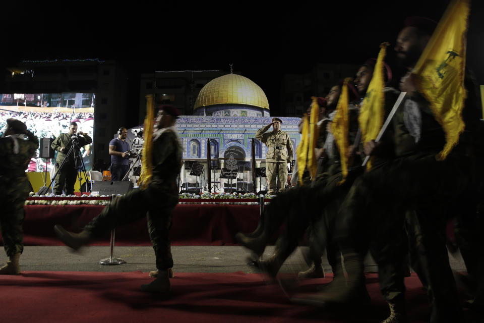 Hezbollah fighters march past a representation of the Dome of the Rock Mosque at a rally to mark Jerusalem day or Al-Quds day, in a southern suburb of Beirut, Lebanon, Friday, May 31, 2019. (AP Photo/Hassan Ammar)