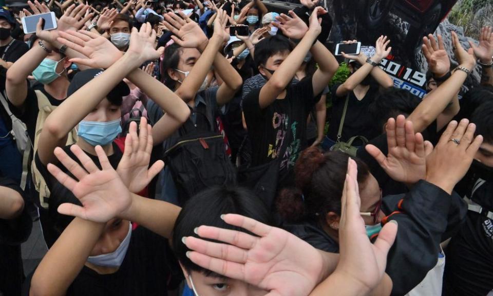 Protesters learn hand gestures and signs to communicate with one another in Bangkok