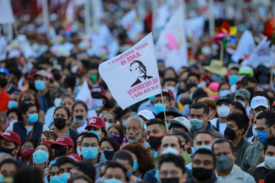 Supporters of López Obrador hold banners in support of the president at Mexico City's Zócalo.