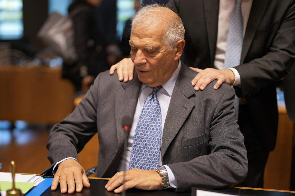 Austria's Foreign Minister Alexander Schallenberg puts his hands on the shoulders of European Union foreign policy chief Josep Borrell during a meeting of EU foreign ministers at the EU Council building in Luxembourg, Monday, Oct. 17, 2022. European Union foreign ministers are gathering in Luxembourg to give the greenlight for a military training mission in Ukraine and to debate possible new sanctions against Iran for its security crackdown on protestors. (AP Photo/Virginia Mayo)