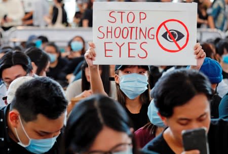 Anti-extradition bill protesters attend a mass demonstration after a woman was shot in the eye during a protest at Hong Kong International Airport, in Hong Kong