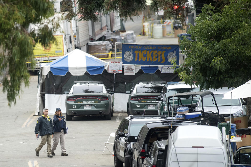 FBI personnel pass a ticket booth at the Gilroy Garlic Festival Monday, July 29, 2019 in Calif., the morning after a gunman killed at least three people, including a 6-year-old boy, and wounding about 15 others. A law enforcement official identified the gunman, who was shot and killed by police, as Santino William Legan. (AP Photo/Noah Berger)