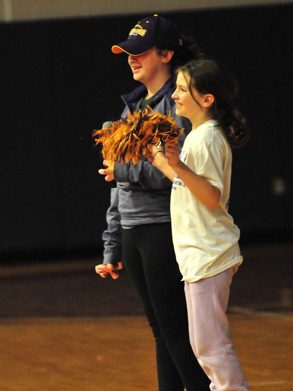 Eleanor Freund, 11, left, and sister Lillian, 9, lead cheers before a large crowd gathered at Ashland University to watch the Eagles claim the NCAA Div. II national championship.