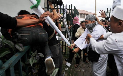 Hardline Indonesian muslims clash with supporters of Indonesian rock star Nazril Ariel following his trial at Bandung court in West Java on January 31. The religious activists pelted the police van carrying the rockstar with rotten eggs and tomatoes as he was escorted to the court, while fans of the husky-voiced heart-throb sang his song "Sahabat" (Friend) and chanted "Free Ariel"