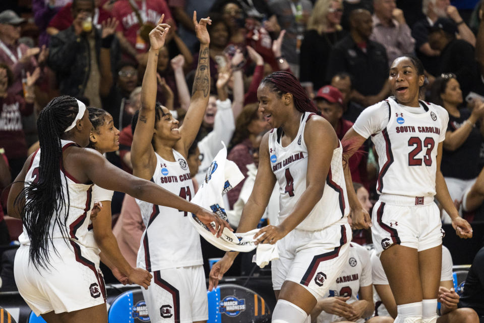 South Carolina's Aliyah Boston (4) celebrates with other players moments before defeating Maryland in an Elite 8 college basketball game of the NCAA Tournament in Greenville, S.C., Monday, March 27, 2023. (AP Photo/Mic Smith)