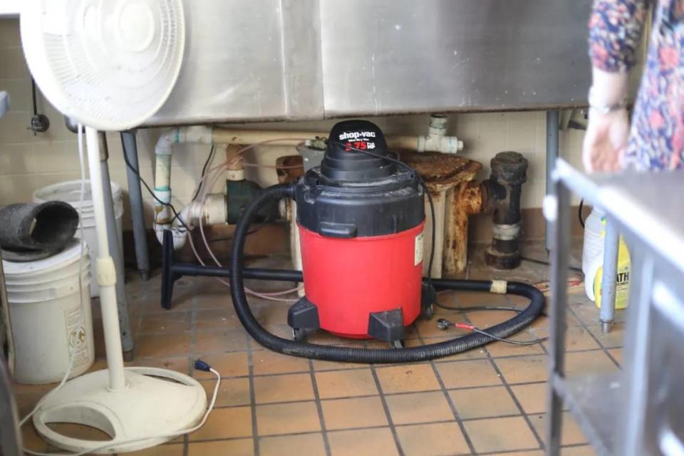 Rusted pipes and a vacuum sit under a sink that has been unusable for years in NEMCC’s culinary arts lab last month. Molly Minta/Mississippi Today