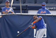 New York Mets Michael Conforto, left, watches as Yoenis Cespedes takes batting practice in the cage before an exhibition game against the New York Yankees, Sunday, July 19, 2020, at Yankee Stadium in New York. (AP Photo/Kathy Willens)