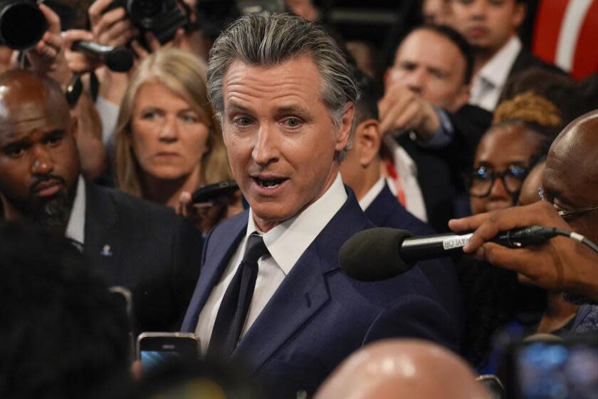 FILE - California Gov. Gavin Newsom speaks to reporters after a presidential debate between President Joe Biden and Republican presidential candidate former President Donald Trump in Atlanta, Thursday, June 27, 2024. On Saturday, June 29, 2024, Newsom signed California's budget to close an estimated $46.8 billion deficit through $16 billion in spending cuts and temporarily raising taxes on some businesses. (AP Photo/John Bazemore, File)