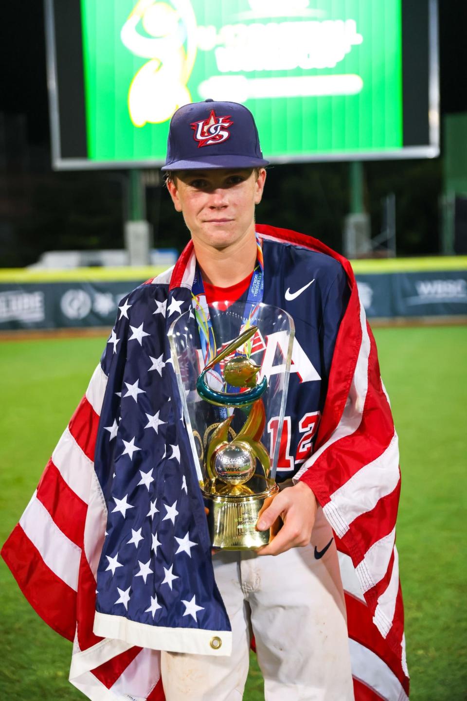 Colin Anderson, wrapped in an American flag, after Team USA defeated Venezuela in the gold medal game of the 12 Baseball World Cup