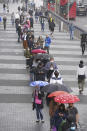 People queue at an NHS Vaccination Clinic at Tottenham Hotspur's stadium in north London, Sunday, June 20, 2021. The NHS is braced for high demand as anyone in England over the age of 18 can now book a Covid-19 vaccination jab. (Yui Mok/PA via AP)