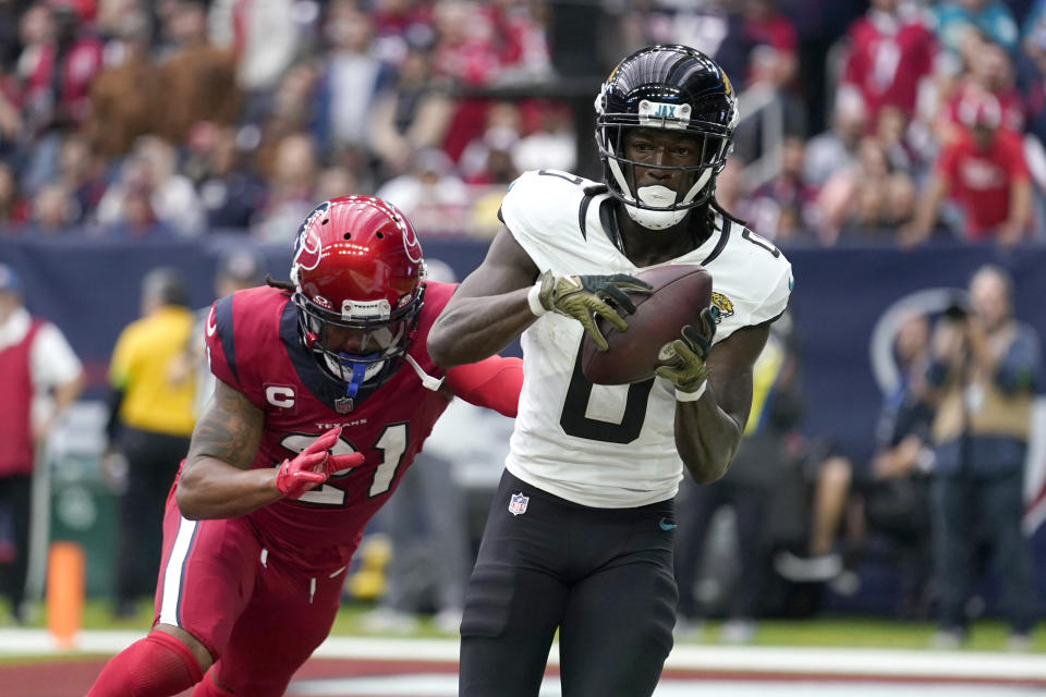 Jacksonville Jaguars wide receiver Calvin Ridley (0) catches a pass for a two-point conversion as Houston Texans' Steven Nelson (21) defends in the second half of an NFL football game in Houston, Sunday, Nov. 26, 2023. (AP Photo/Eric Gay)