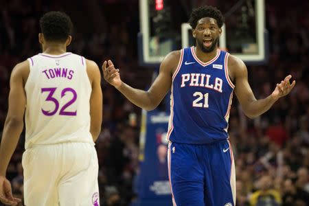 FILE PHOTO: Jan 15, 2019; Philadelphia, PA, USA; Philadelphia 76ers center Joel Embiid (21) reacts to his foul call in front of Minnesota Timberwolves center Karl-Anthony Towns (32) during the third quarter at Wells Fargo Center. Mandatory Credit: Bill Streicher-USA TODAY Sports