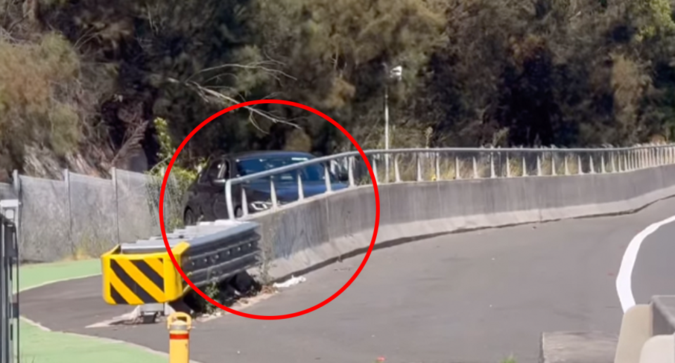 An unmarked NSW Police Highway Patrol car on the Alfords Point Bridge in Sydney's South parked on a bicycle path. 