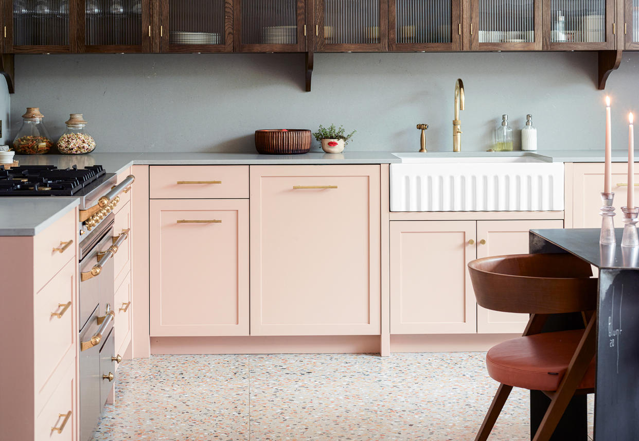  calming kitchen with soft pink cabinets and grey walls 