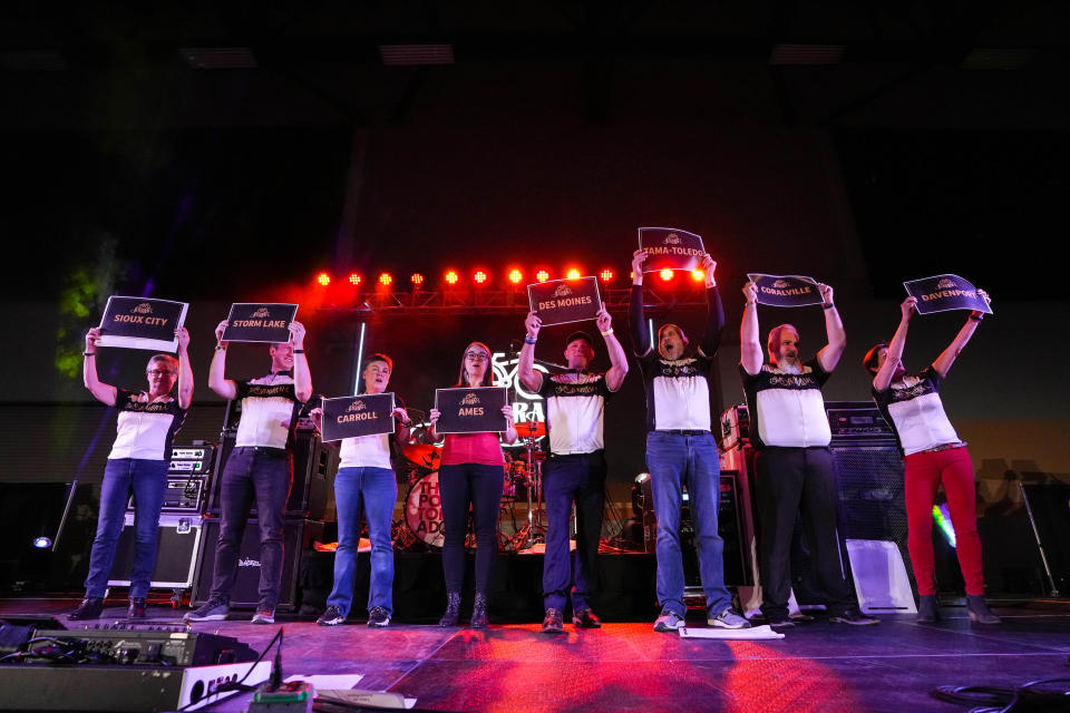 Members of RAGBRAI hold up the route signs for the 2023 RAGBRAI during the RAGBRAI route announcement party at Hy-Vee Hall in Des Moines on Saturday, Jan. 28, 2023.