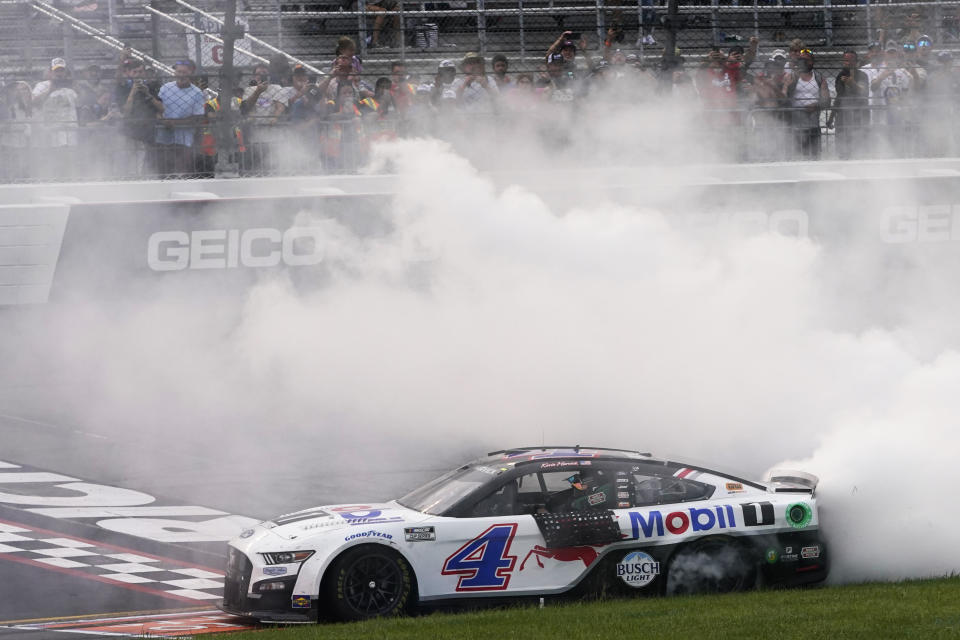 Kevin Harvick (4) does a burnout as he celebrates after winning a NASCAR Cup Series auto race at Richmond Raceway, Sunday, Aug. 14, 2022, in Richmond, Va. (AP Photo/Steve Helber)
