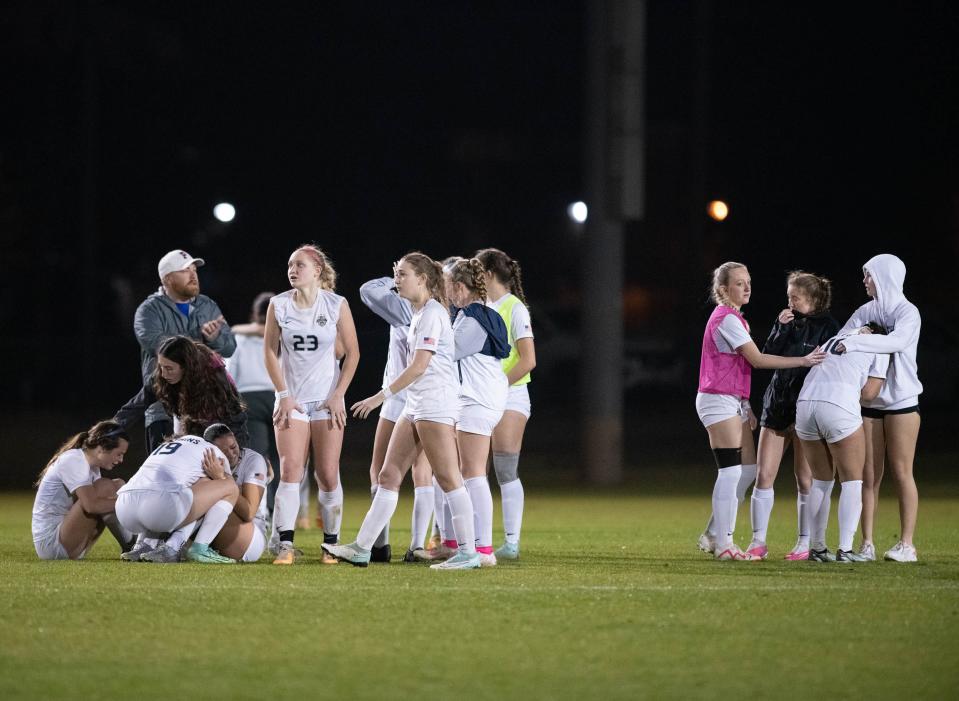 The Dolphins console each other after a heartbreaking defeat in penalty kicks overtime during the Pace vs Gulf Breeze girls playoff soccer game at Ashton Brosnaham Park on Friday, Jan. 26, 2024.