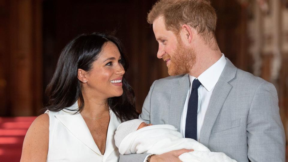 Prince Harry, Duke of Sussex, and his wife Meghan, Duchess of Sussex, pose for a photo with their newborn baby son, Archie Harrison Mountbatten-Windsor, in St George's Hall at Windsor Castle in Windsor, west of London on May 8, 2019.