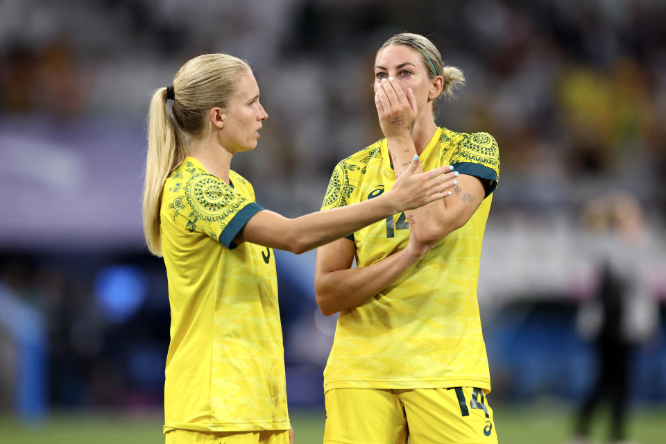 Kaitlyn Torpey and Alanna Kennedy look dejected.