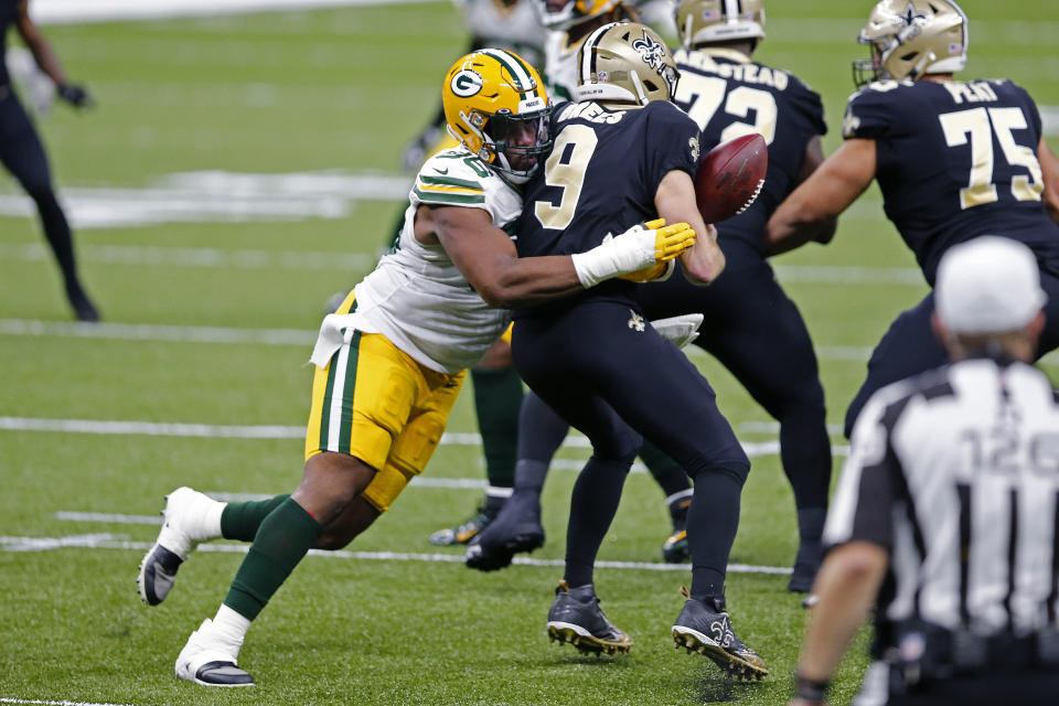 New Orleans Saints quarterback Drew Brees (9) loses the ball as he is hit by Green Bay Packers linebacker Delontae Scott (98) in the first half of an NFL football game in New Orleans, Sunday, Sept. 27, 2020. (AP Photo/Brett Duke)