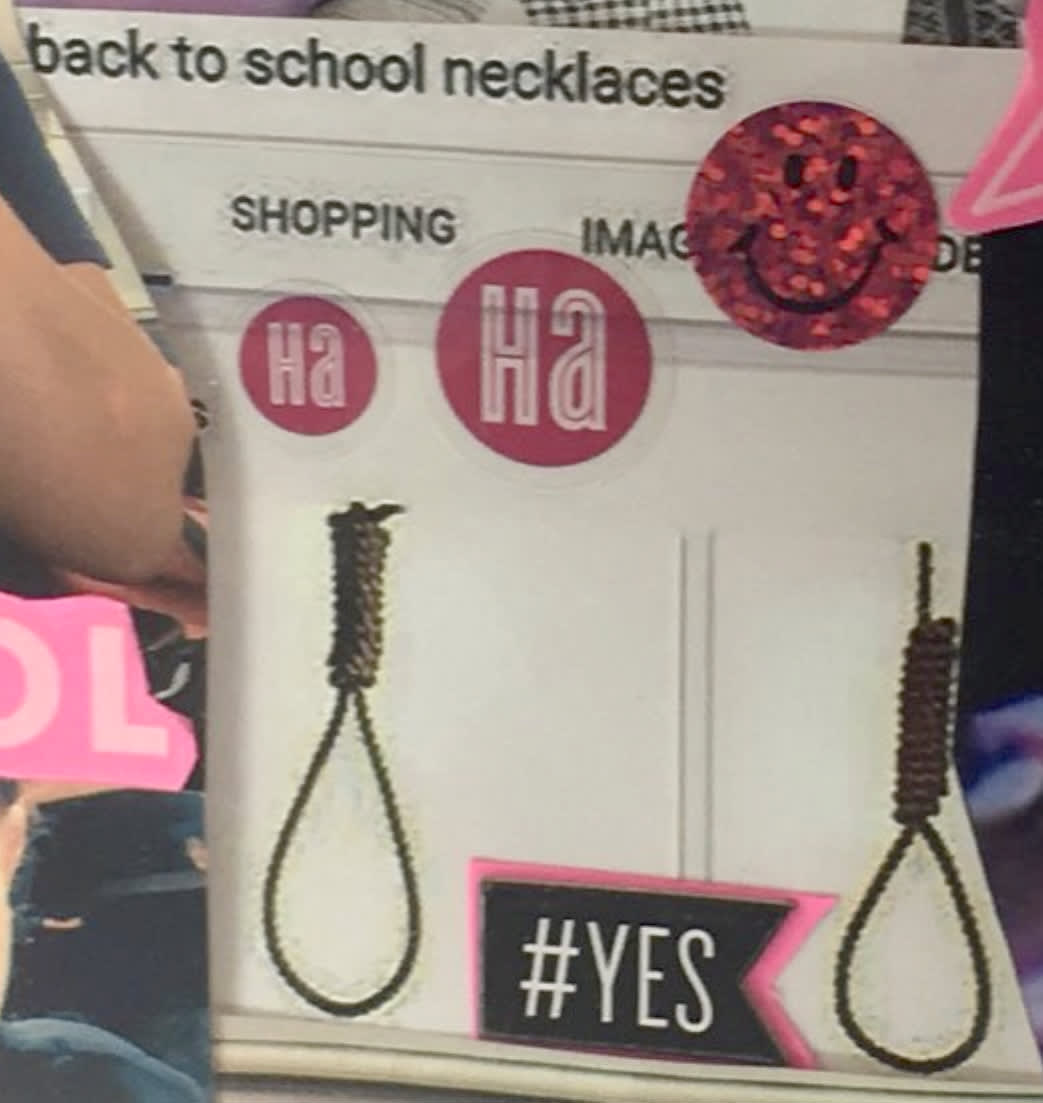 Image: A photo displayed inside a classroom shows two nooses labeled 