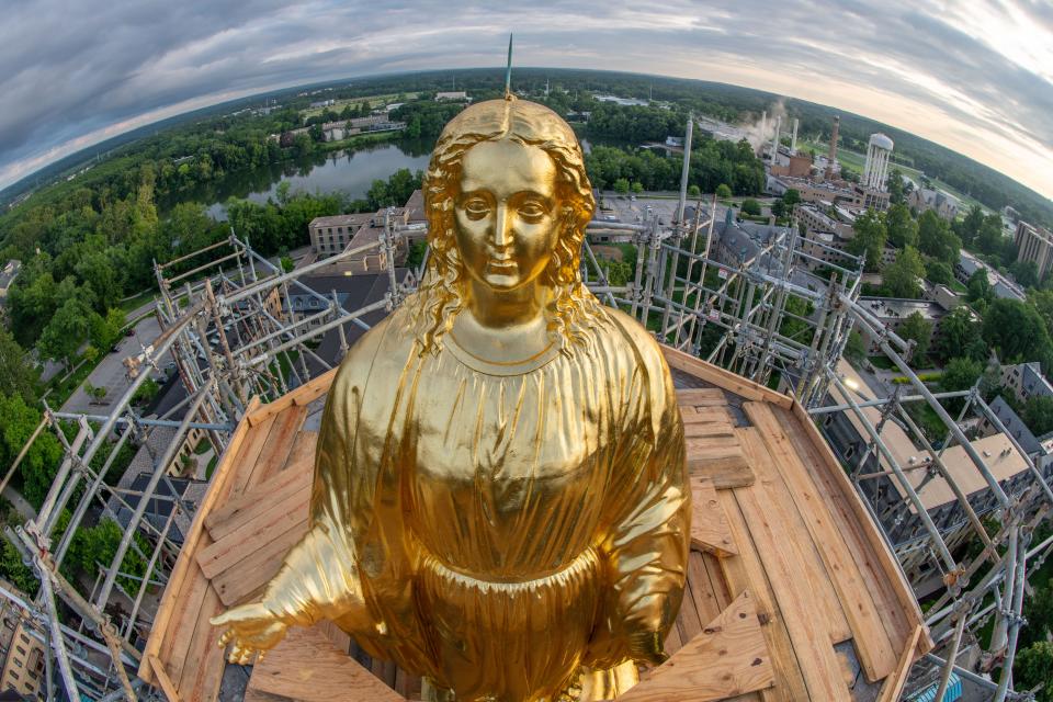 The Statue of Mary gleams in July after being regilded and polished atop the Golden Dome on the University of Notre Dame's Main Building in July.