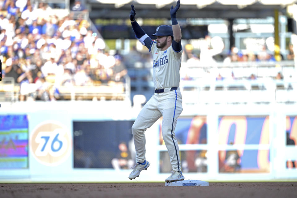 Los Angeles Dodgers' Gavin Lux reacts after hitting an RBI double in the first inning against the Pittsburgh Pirates during a baseball game Saturday, Aug. 10, 2024, in Los Angeles. (AP Photo/Jayne-Kamin-Oncea)