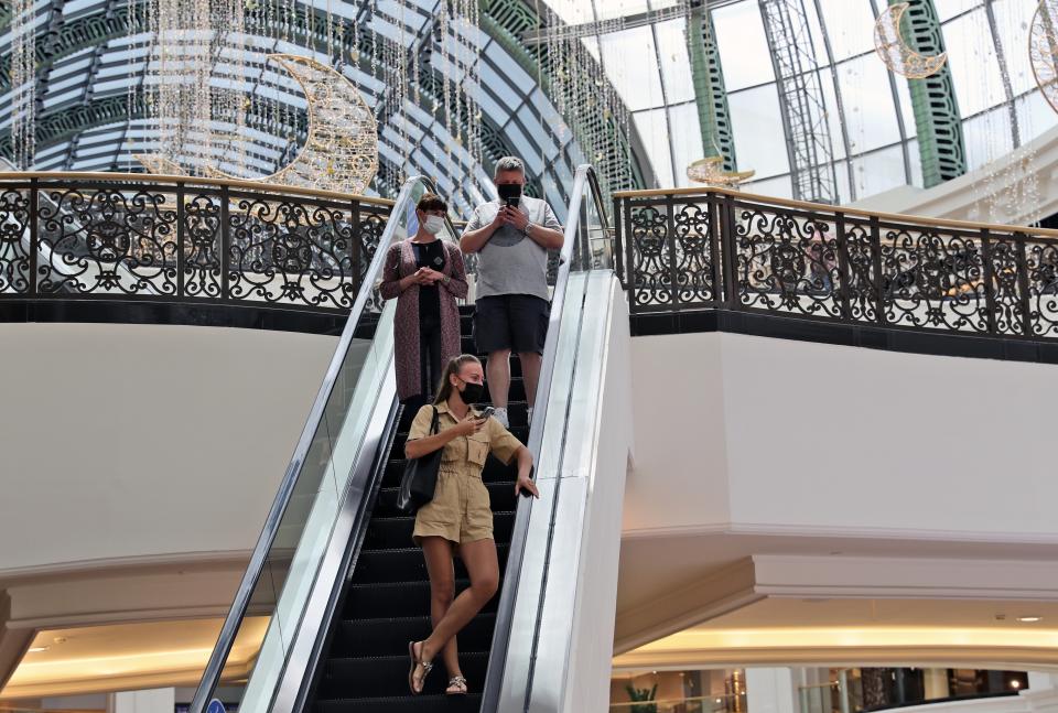 People visit the Mall of the Emirates in Dubai, United Arab Emirates, Thursday, April 15, 2021. The Middle East's largest operator of malls, Majid Al Futtaim, expects revenue and earnings to climb back to pre-pandemic levels by the end of next year and is moving full steam ahead with plans to develop its biggest mall ever. (AP Photo/Kamran Jebreili)